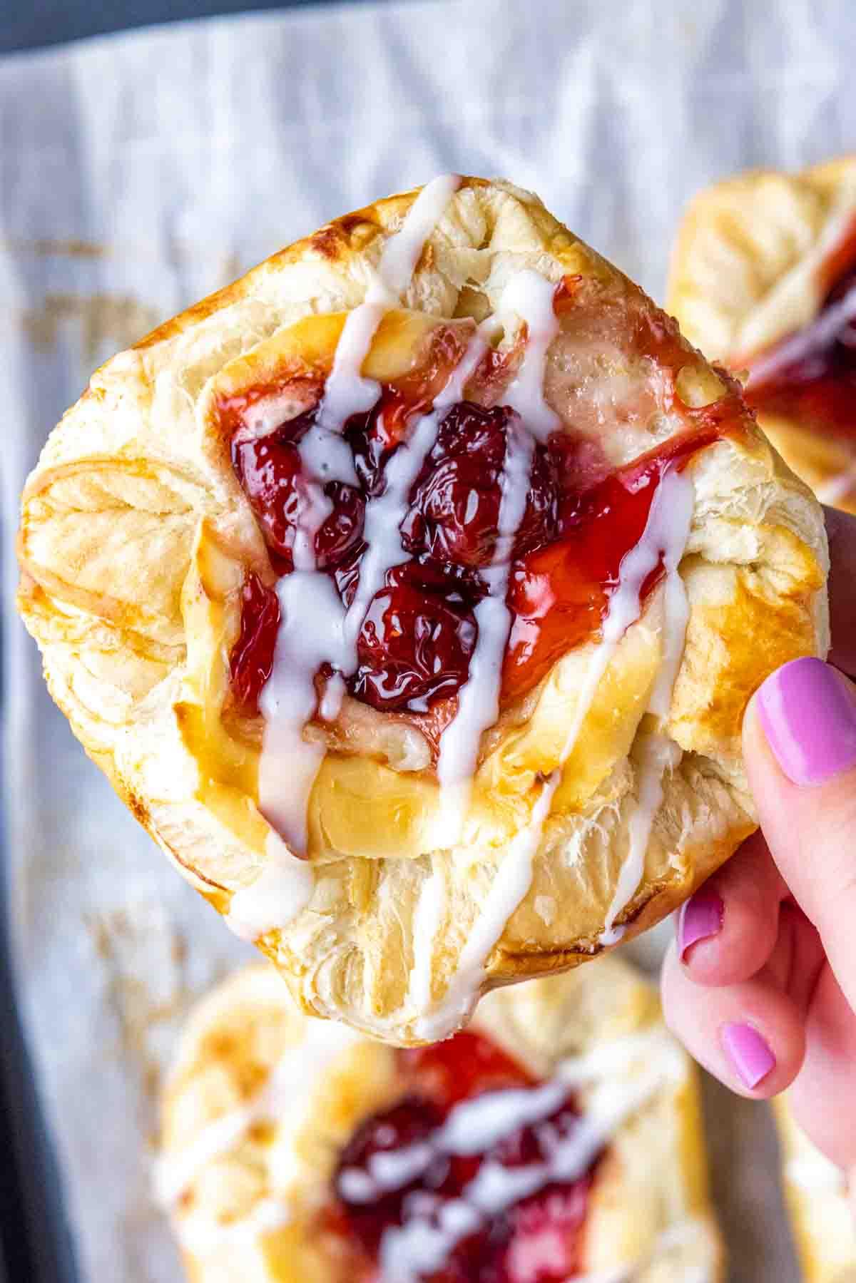 Einfacher Kirschplunder mit Frischkäse 3 Ein Kirsch-Dänisch haltend