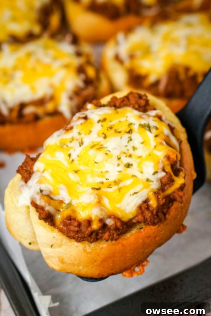 Sloppy Joe Stuffed Garlic Bread 2 Delicious Garlic Bread Sloppy Joes topped with melted cheese, ready to be served.