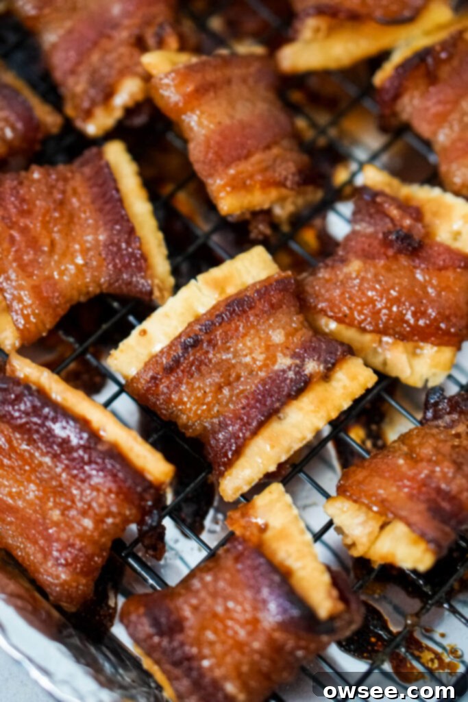 Sweet Heat Bacon Crisps 2 A fresh batch of crispy Cajun Candied Bacon Crackers cooling on a wire rack on a sheet tray, ready to be enjoyed.