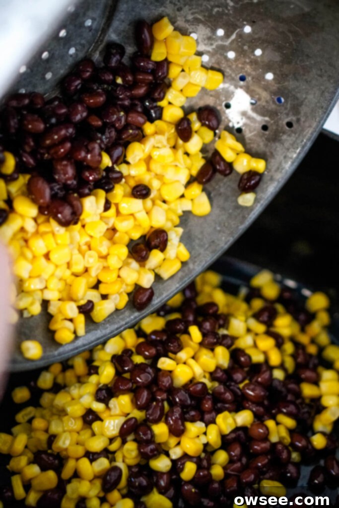 Effortless Seven Can Chicken Taco Soup 6 Drained and rinsed black beans and corn, separated in a bowl, showing they are prepared for the soup.