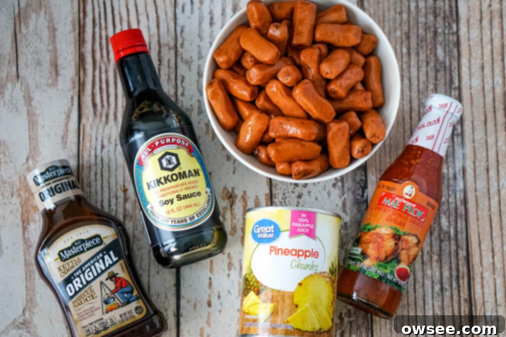 Hawaiian Little Smokies 5 Original barbecue sauce, Kikkoman Soy Sauce, a bowl of Lit'l Smokies, a can of pineapple chunks, and Mae Ploy sweet chili sauce—all ingredients for Hawaiian Lit'l Smokies.
