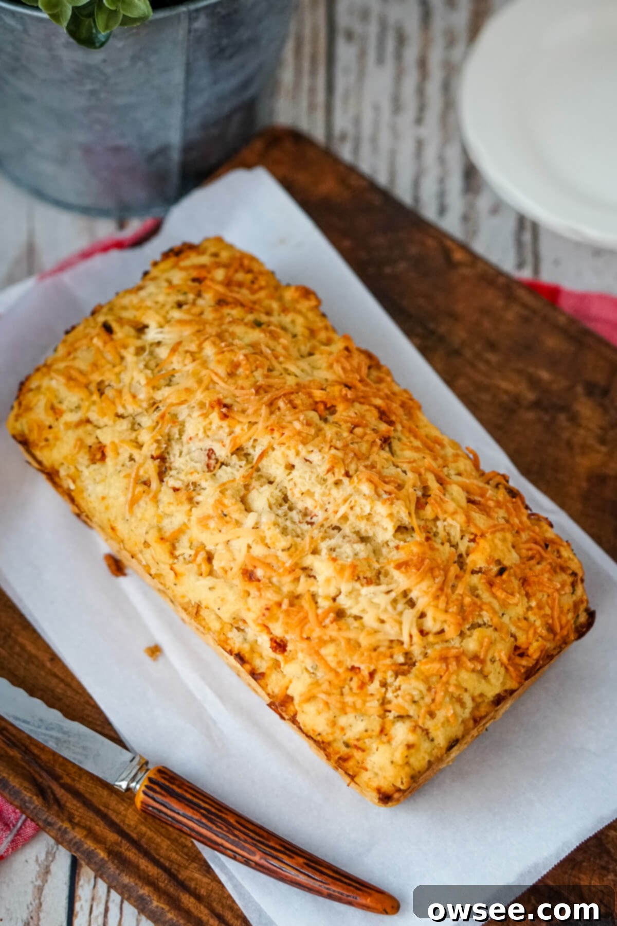 Sun-Kissed Tomato Parmesan Beer Bread 11 A hero shot of a beautiful loaf of Sun-dried Tomato and Parmesan Beer Bread, ready to be sliced and served.