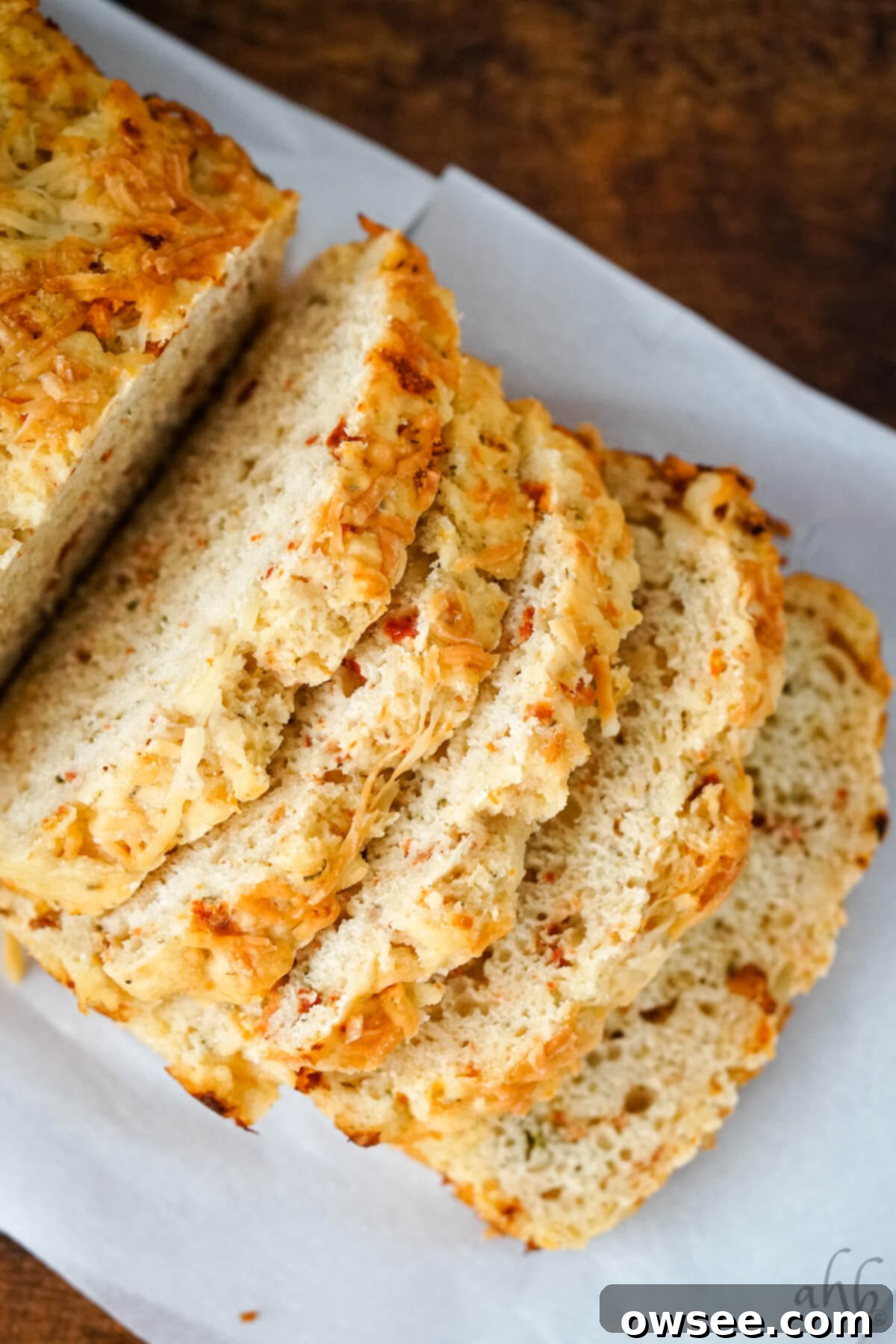 Sun-Kissed Tomato Parmesan Beer Bread 4 Five thick slices of golden Sun-dried Tomato and Parmesan Beer Bread arranged artfully.