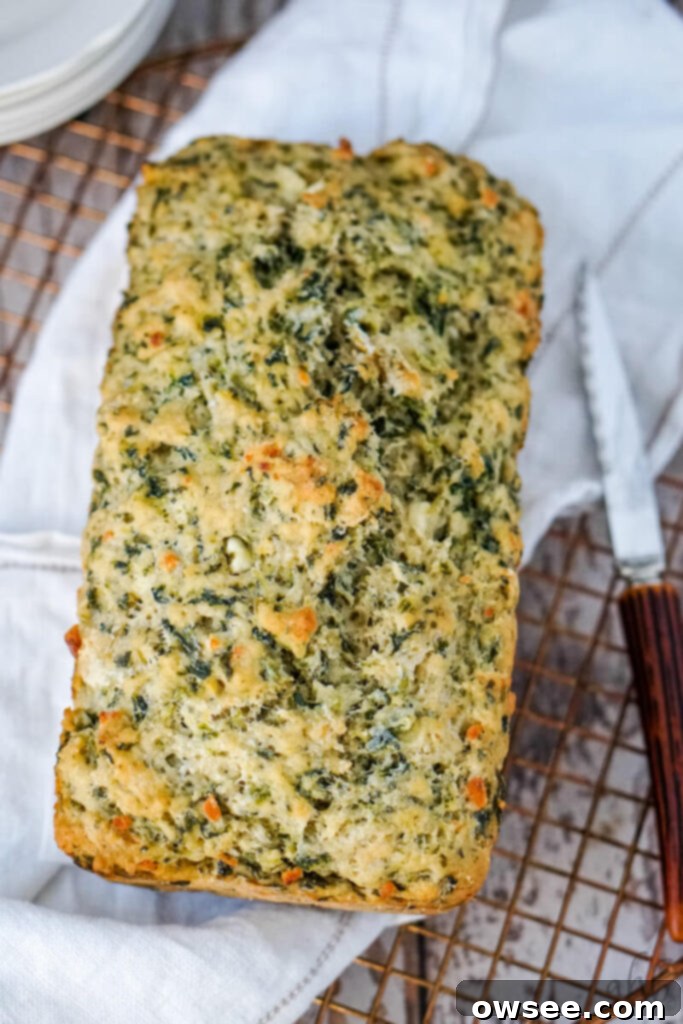 Savory Spinach Feta Beer Bread 10 The golden brown loaf is cooled on a rack.