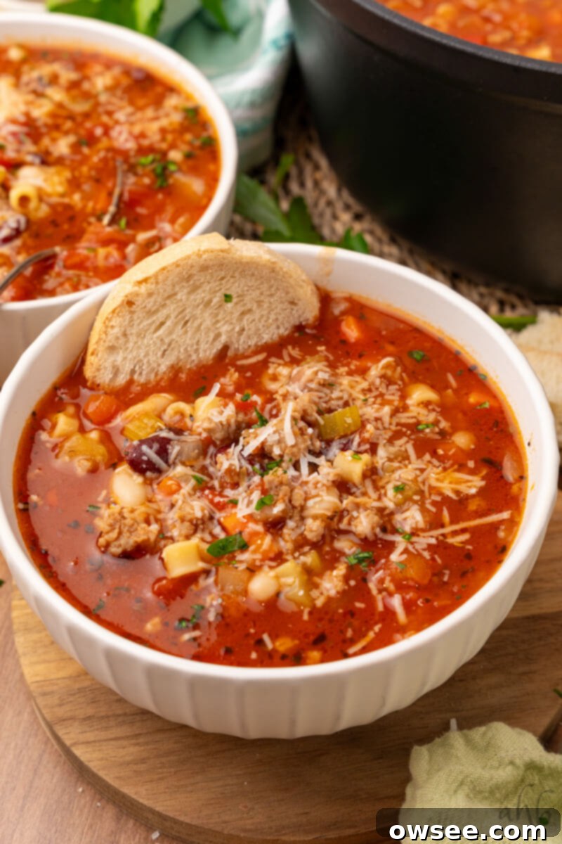 Savory Sausage Pasta Fagioli: An Effortless Comfort 4 Two bowls of inviting Easy Pasta Fagioli soup are garnished with fresh herbs and served alongside a crusty slice of artisanal bread.