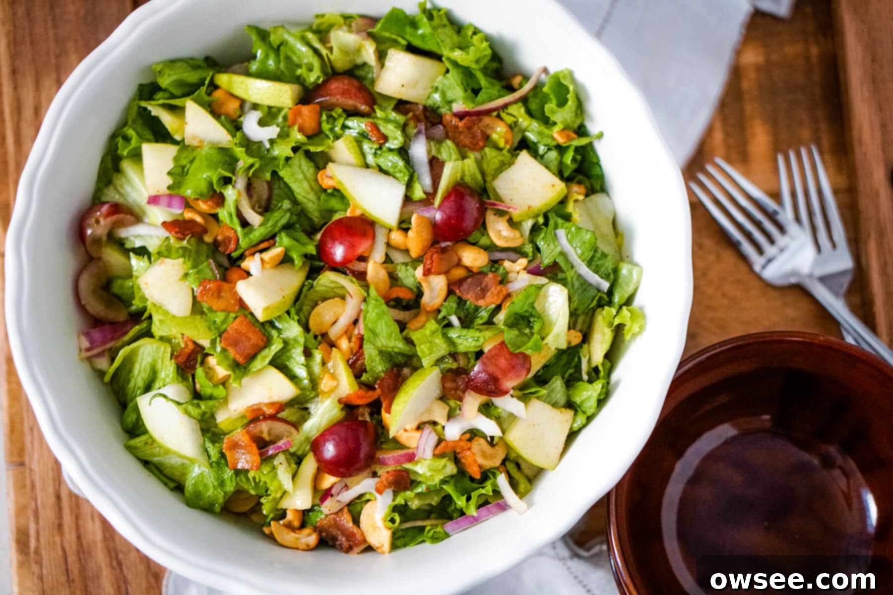 Cashew Salad 2 A white bowl of Cashew Nut Salad next to a brown bowl and two forks.