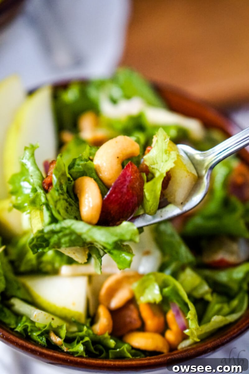 Cashew Salad 4 A forkful of the Cashew Nut Salad is taken from the brown bowl.