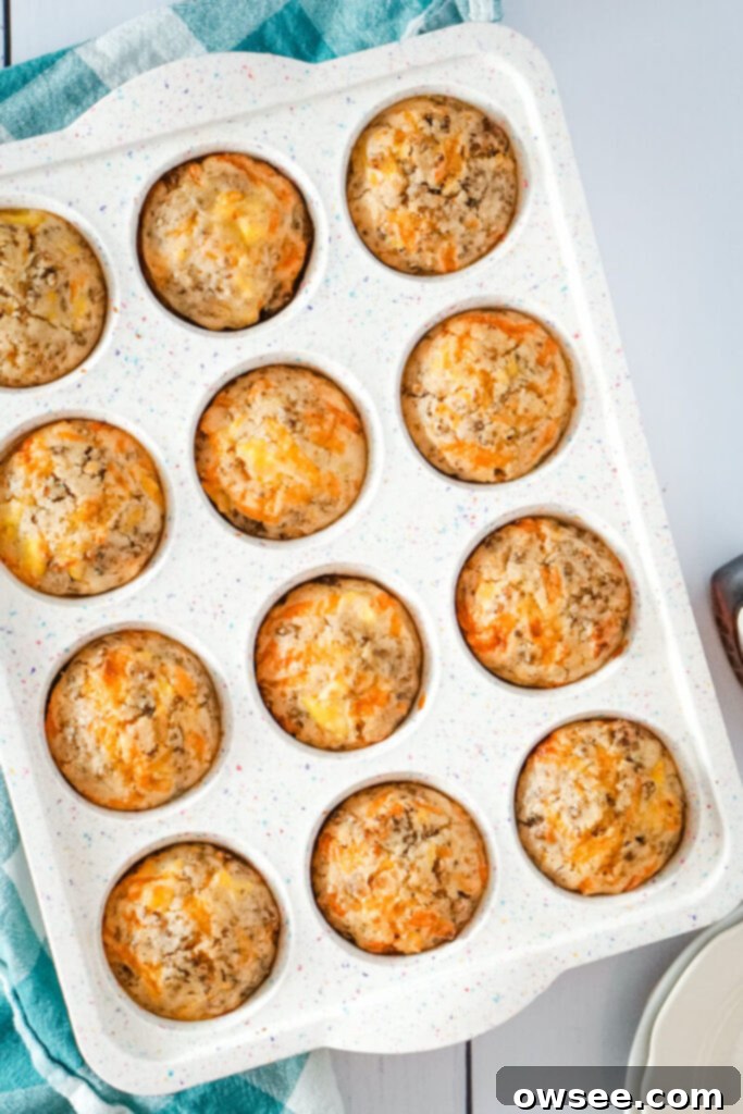 All-in-One Breakfast Muffins 9 Golden brown McGriddle muffins, perfectly domed, have been freshly baked and are cooling in the muffin tin, still warm from the oven.