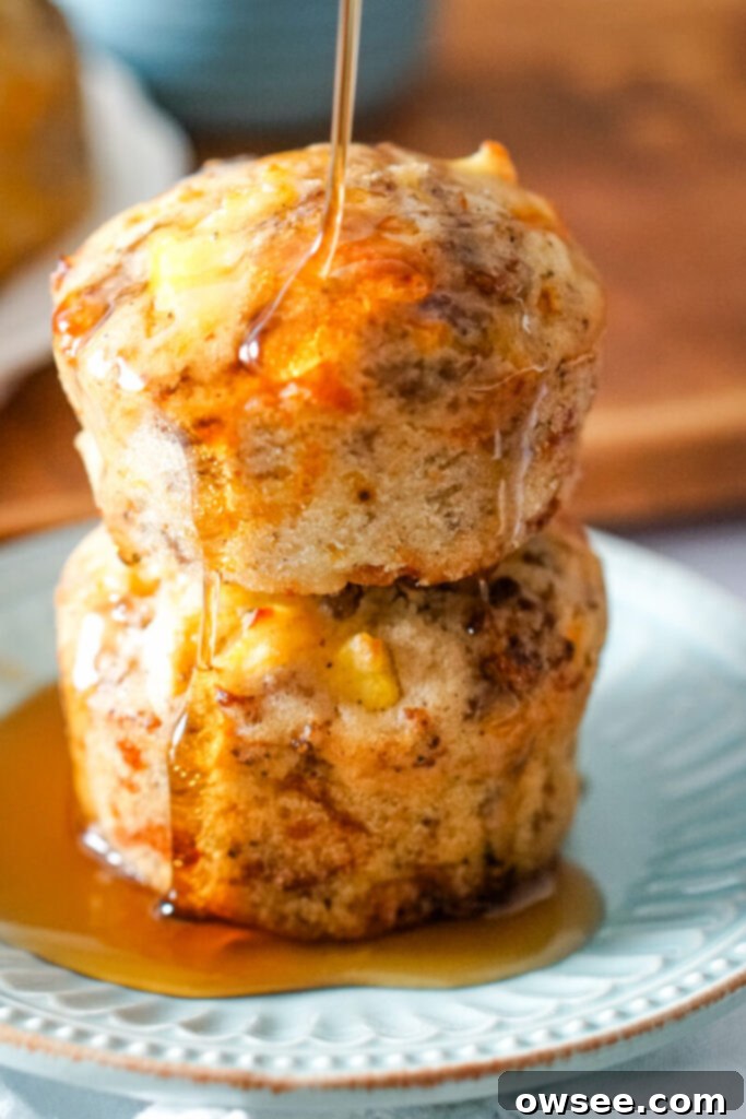 All-in-One Breakfast Muffins 10 Two McGriddle muffins are stacked on a blue plate and covered with syrup, ready to be enjoyed as a sweet and savory breakfast.