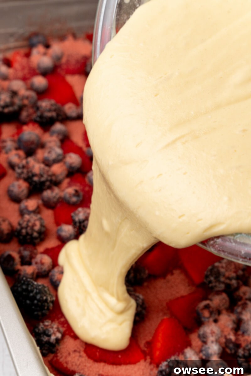 Caramelized Berry Flip Cake 8 The smooth, yellow cake batter is gently and evenly poured over the layer of berries, sugar, and gelatin in the prepared baking pan.
