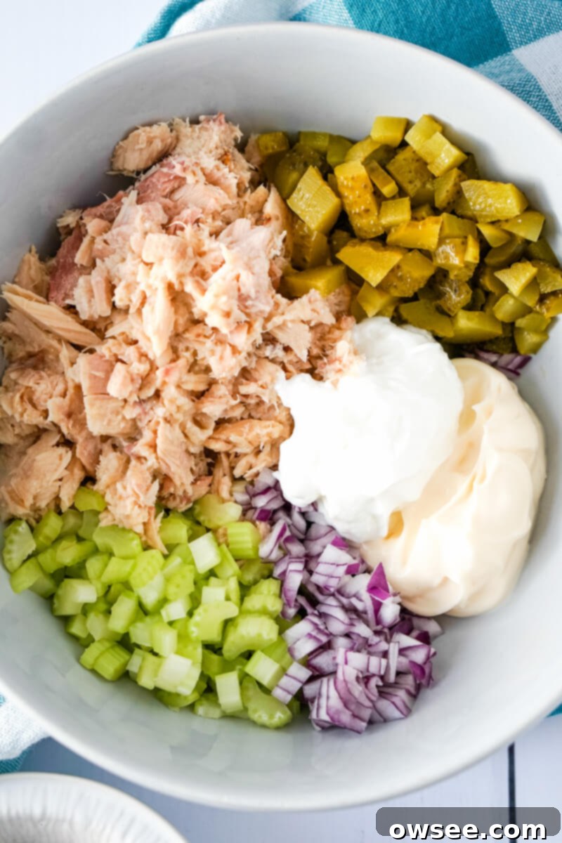 Dill-icious Tuna Salad 5 All the fresh ingredients for Dill Pickle Tuna Salad are combined in a large mixing bowl, ready to be stirred.