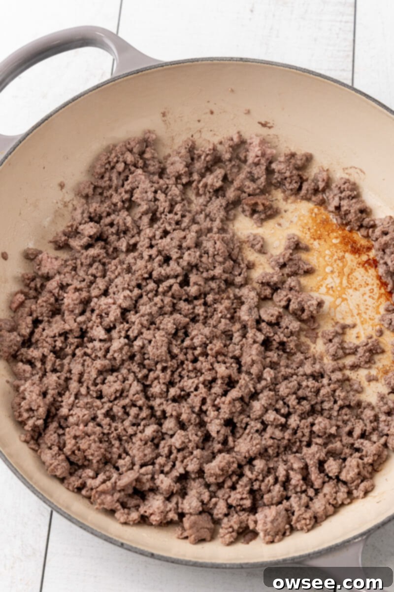 Taco Spaghetti Fiesta 6 A skillet filled with perfectly browned and thoroughly drained lean ground beef, ready for the next step of the Cheesy Taco Spaghetti recipe.