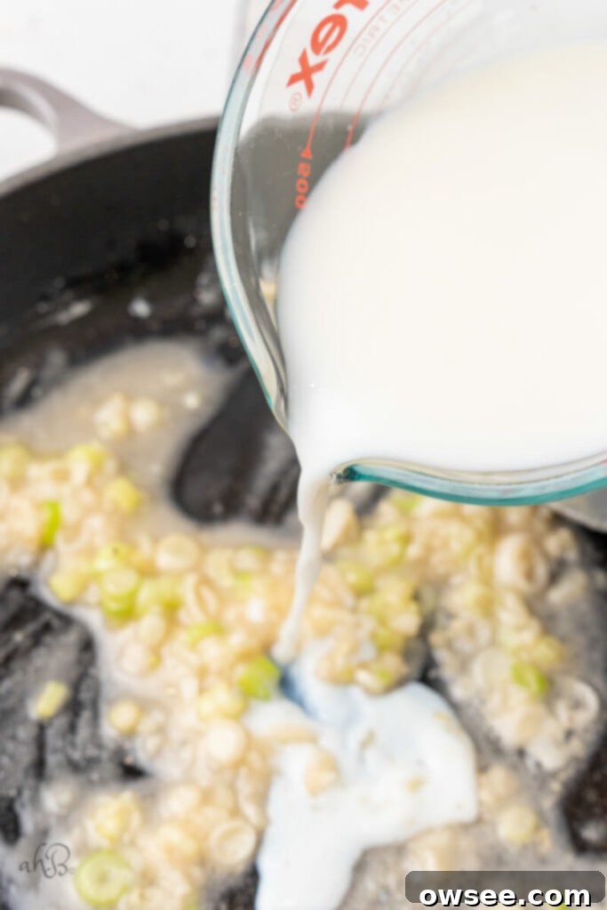 Creamy Tang Pasta 8 Milk is poured into the skillet.
