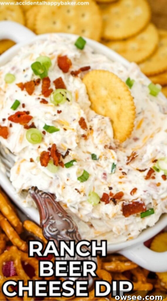 Creamy Ranch Beer Cheese Dip 11 Delicious Ranch Beer Cheese Dip garnished with green onions and bacon, served with various dippers like pretzels and crackers.