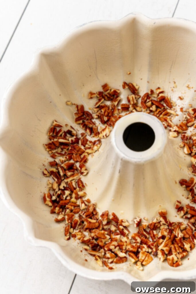 Gooey Caramel Banana Pull-Apart Bread 7 Chopped pecans lay evenly in the bottom of a Bundt pan.