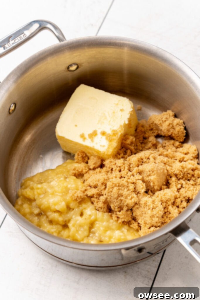Gooey Caramel Banana Pull-Apart Bread 8 Butter, brown sugar, and mashed bananas are added to a pot on the stovetop.