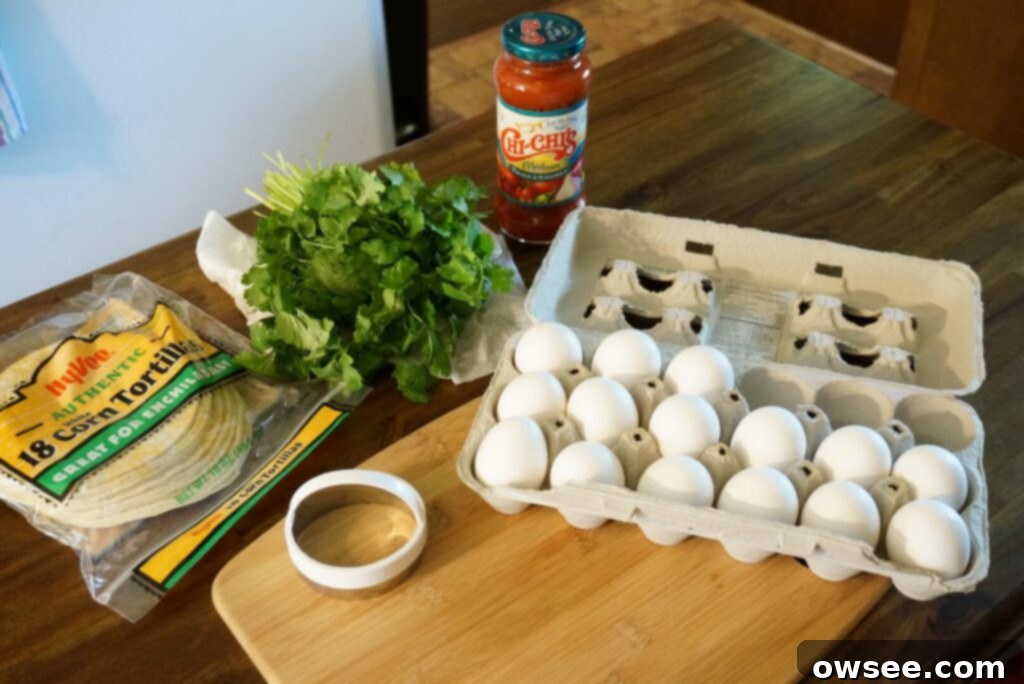 Mexican Huevo in a Hole 4 Corn tortillas, cilantro, salsa, eggs, a biscuit cutter and a cutting board sitting on a counter.