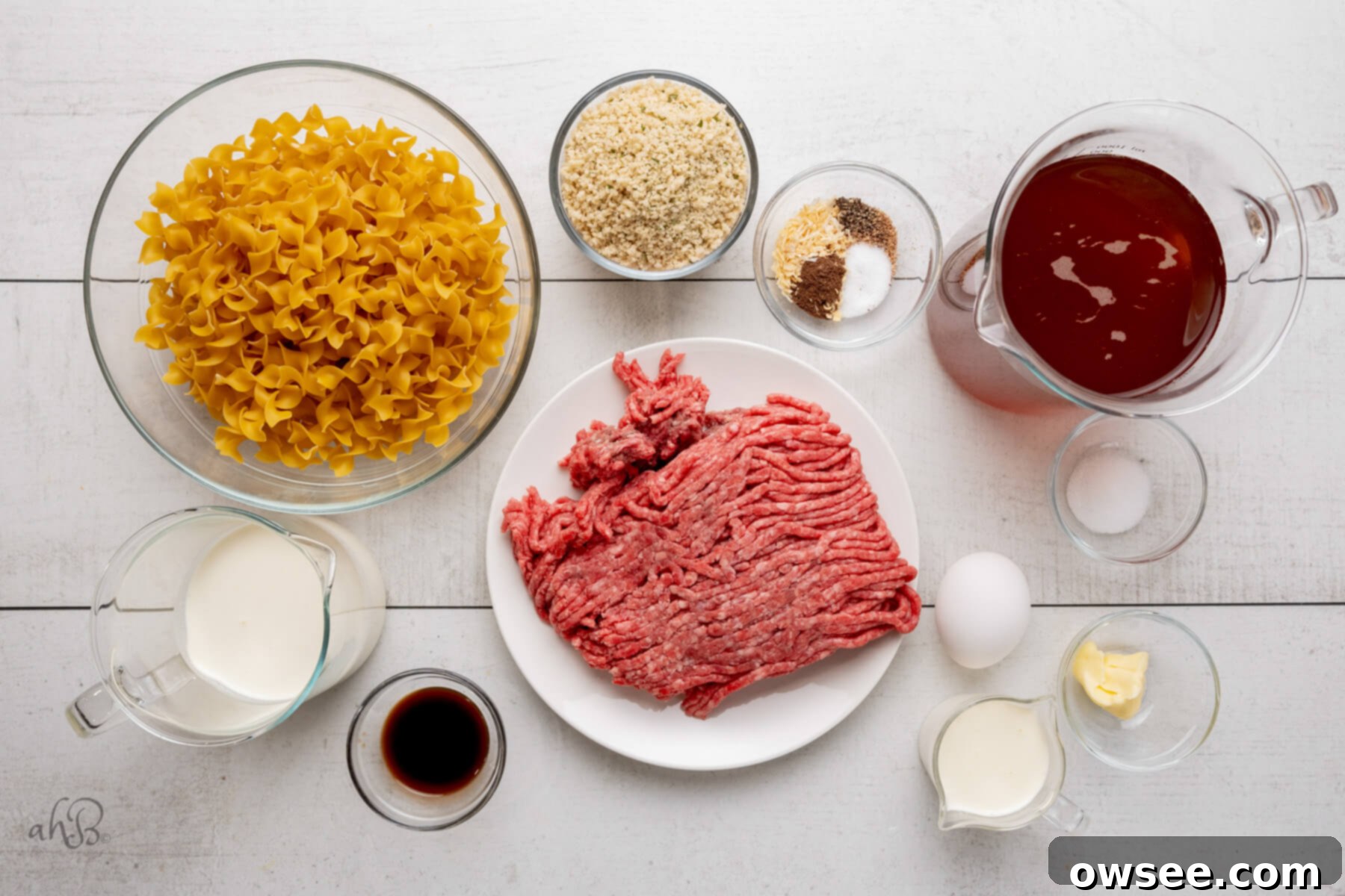 Creamy One Pot Swedish Meatballs and Noodles 5 The ingredients for Swedish meatballs, including ground beef, spices, and breadcrumbs, and the ingredients for the gravy, like broth and cream, are neatly laid out on a table.