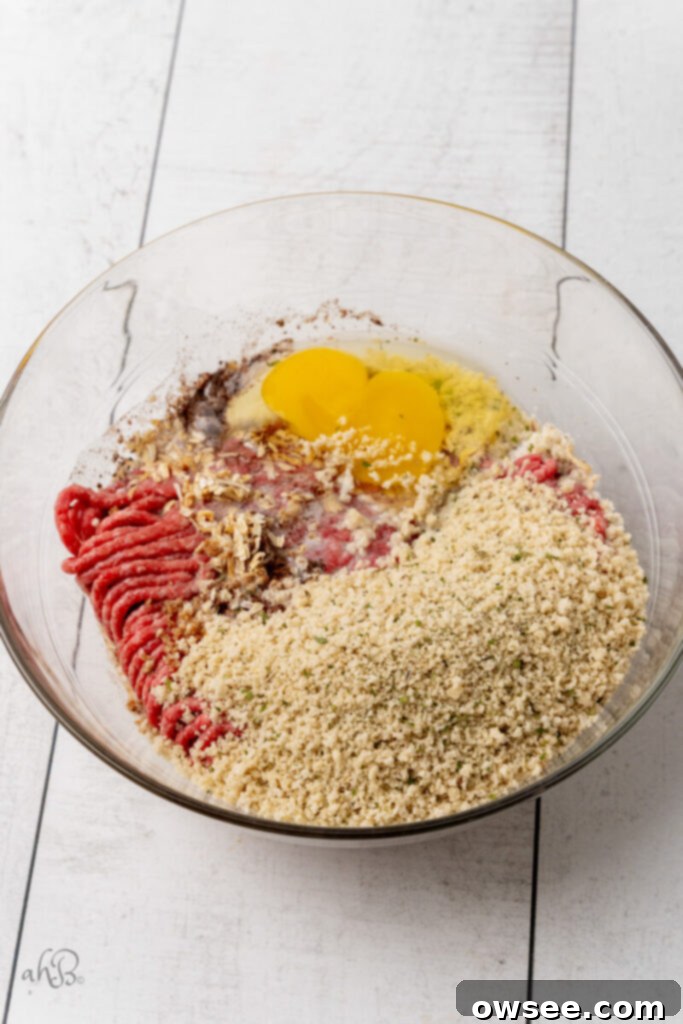 Creamy One Pot Swedish Meatballs and Noodles 6 A clear glass bowl full of the ingredients for the Swedish meatballs, mixed and ready for shaping.