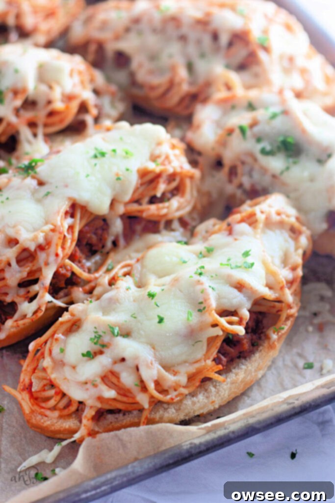 Quick Spaghetti Bread 2 A slice of spaghetti topped garlic bread on a cookie sheet.