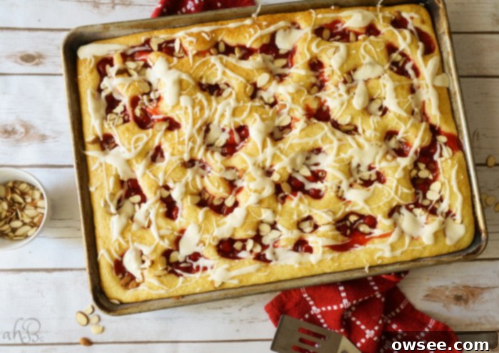 Cherry Almond Delights 6 Platter of freshly baked Cherry Almond Squares, neatly cut and glazed, ready to be served.