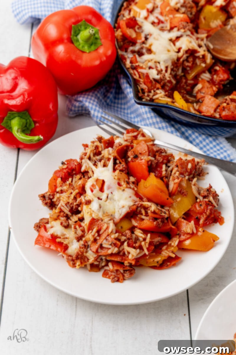 One-Pan Pizza Pepper Skillet 2 A serving of Pizza Unstuffed Peppers Skillet is placed on a white plate.
