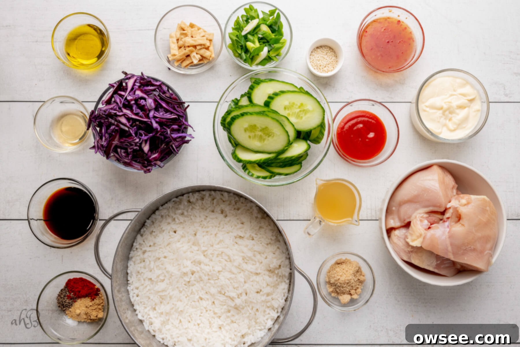 Bold Bang Bang Chicken Bowls 5 The ingredients for Bang Bang Chicken Bowls are separated out into individual glass bowls, neatly arranged.