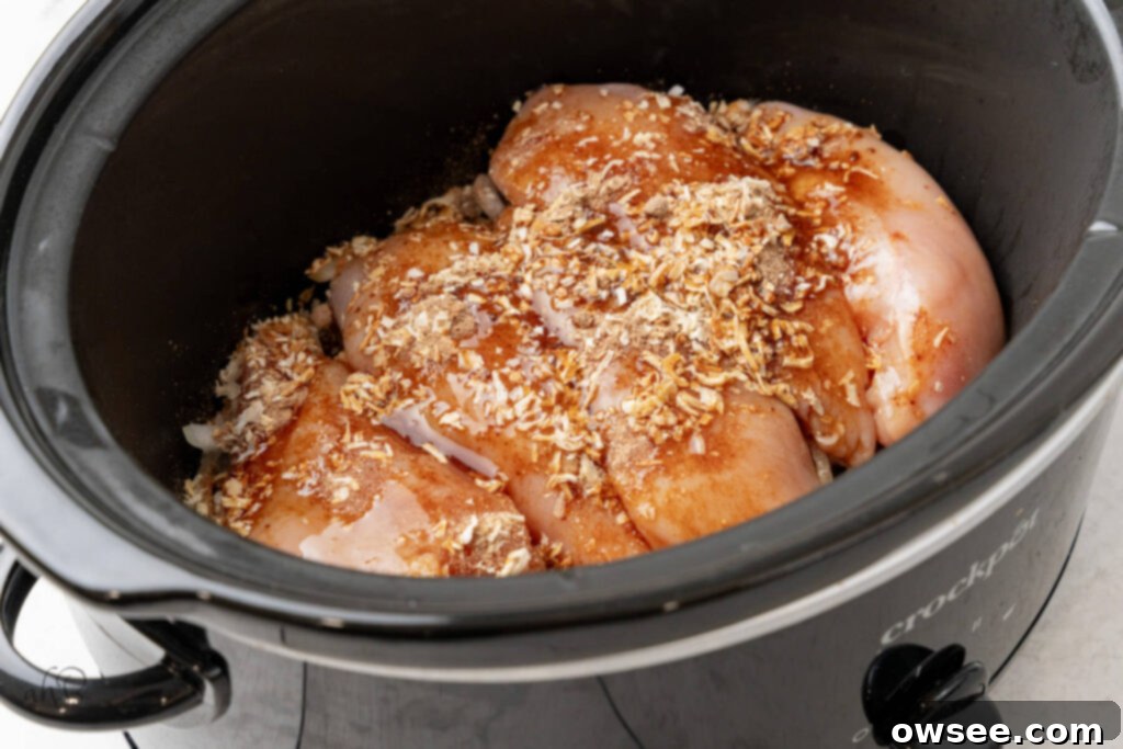Slow Cooker French Onion Chicken 6 Chicken, consommé, and onion soup mix are added to the crockpot.