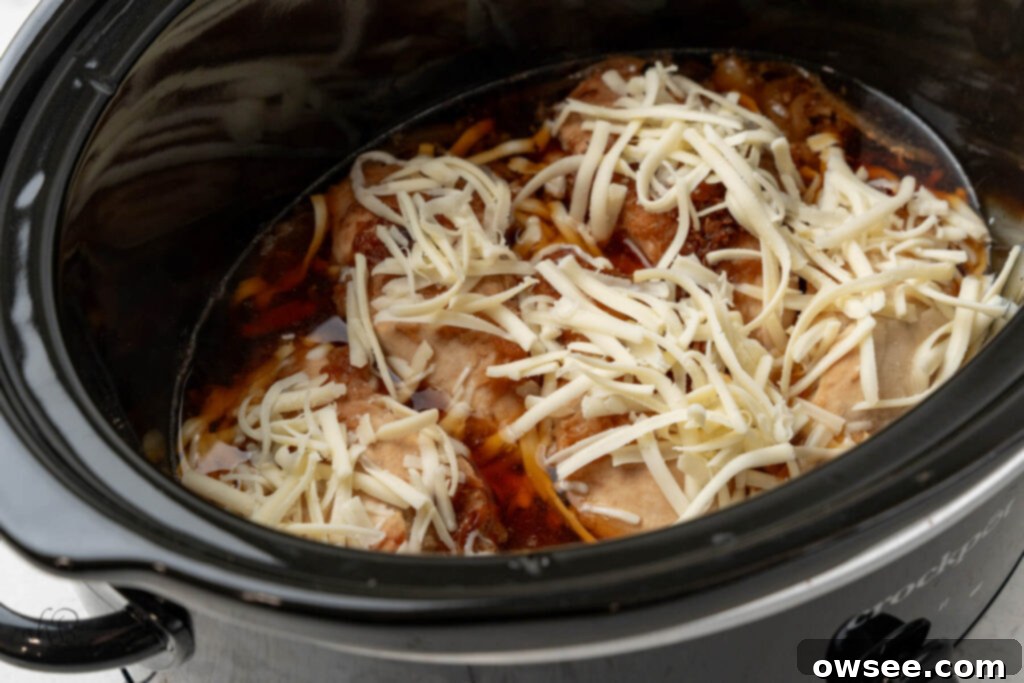 Slow Cooker French Onion Chicken 8 Shredded cheese is added to the crockpot.