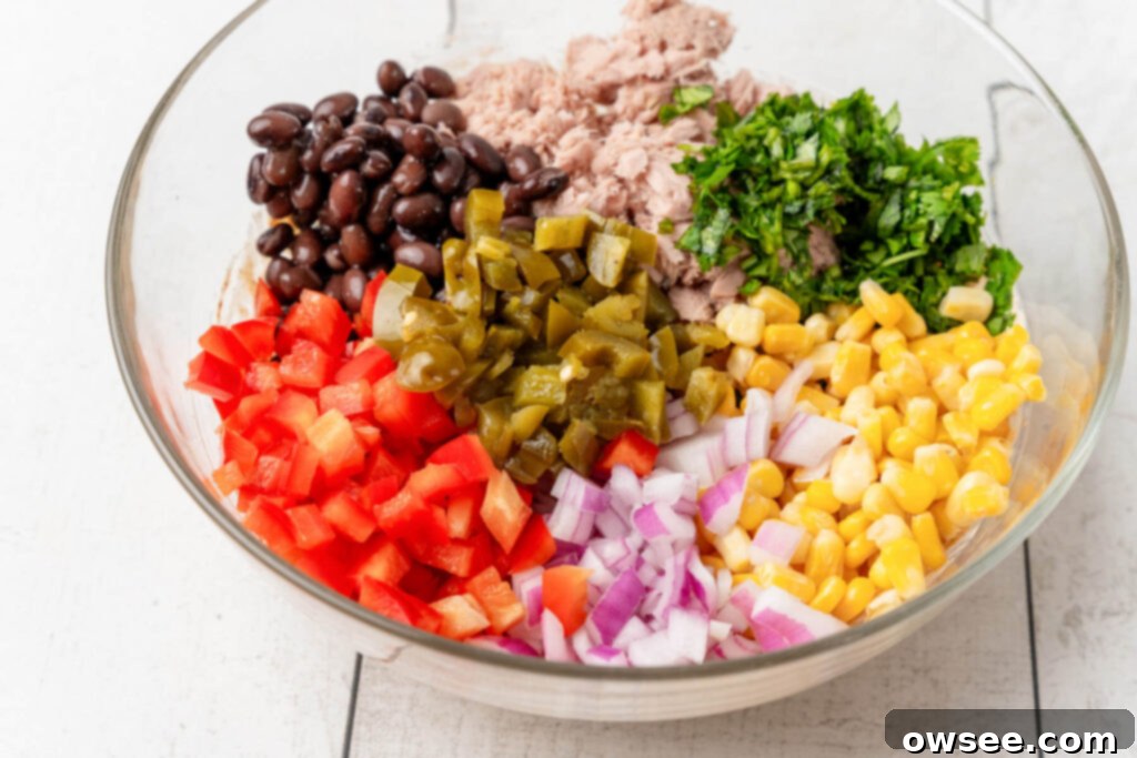 Vibrant Mexican Tuna Medley 7 The tuna and fresh ingredients are added to the mixing bowl with the dressing.