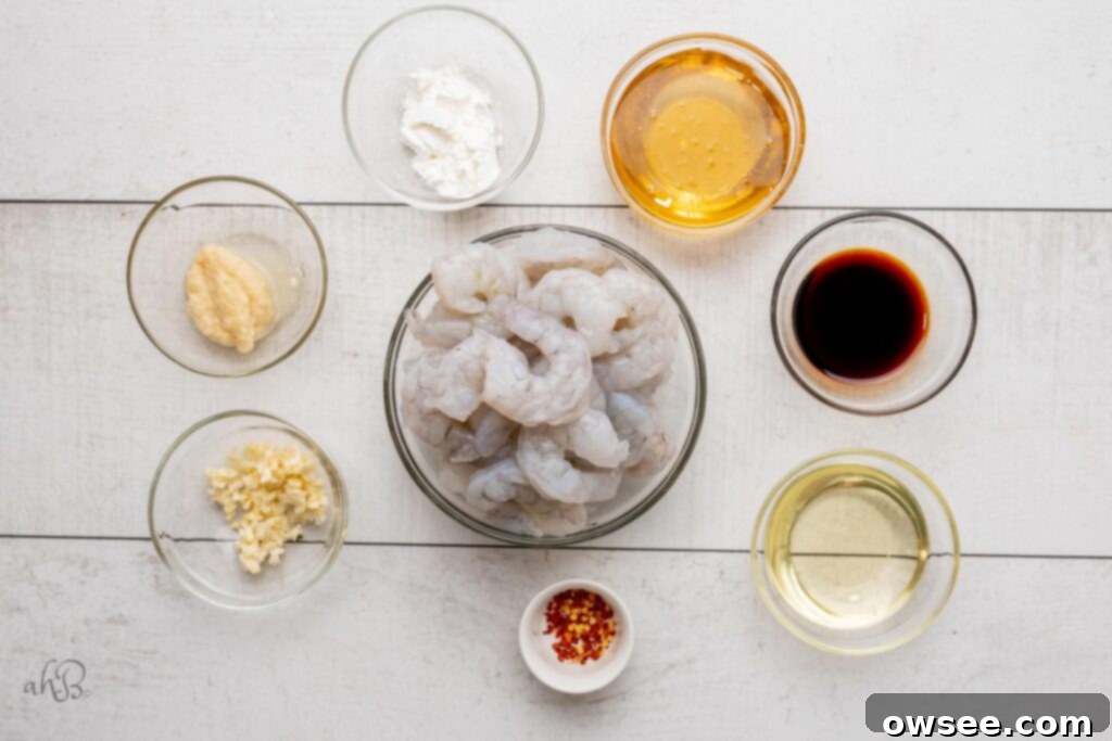 Honey Garlic Glazed Shrimp 5 The ingredients needed to make honey garlic shrimp: chopped garlic, minced ginger, cornstarch, honey, soy sauce, vegetable oil, crushed red pepper, and raw shrimp.