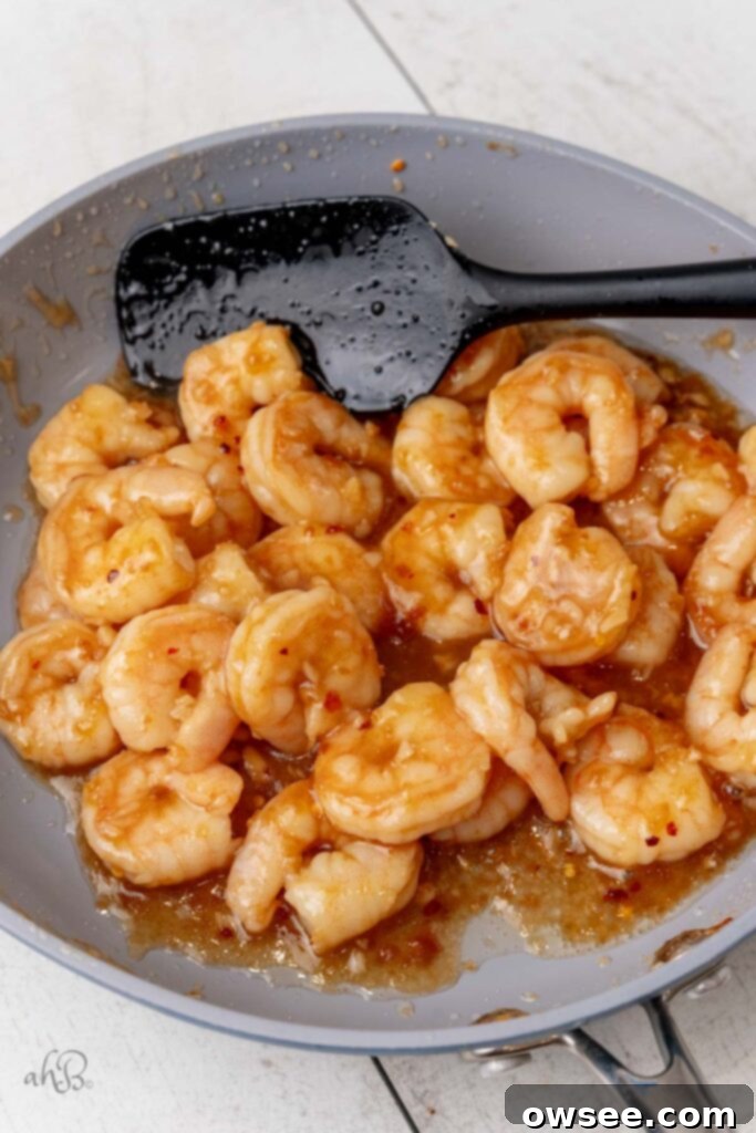 Honey Garlic Glazed Shrimp 10 The honey and crushed red pepper are added to the pan as the shrimp finish cooking.