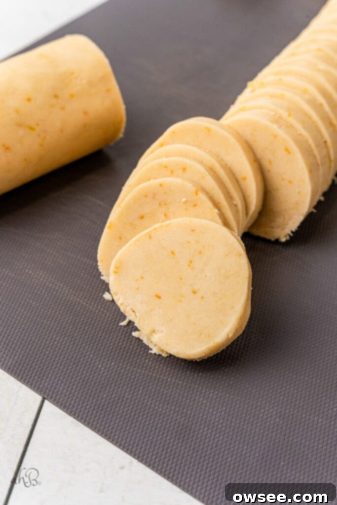 Decadent Orange Chocolate Shortbread 10 The log is cut into slices of cookie dough.
