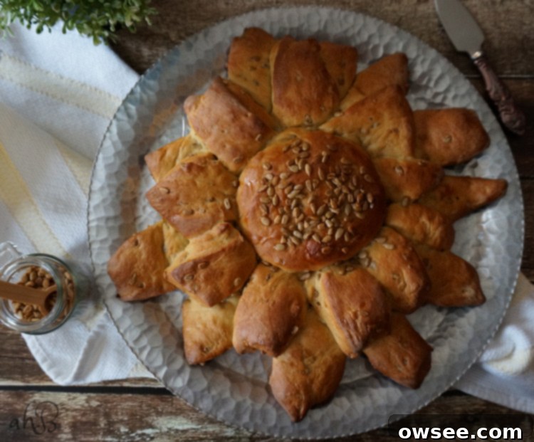 A perfectly sliced loaf of Sunflower Bread, revealing its golden crumb and scattered sunflower seeds.