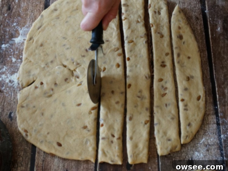 A hand reaching for a warm slice of homemade Sunflower Bread.