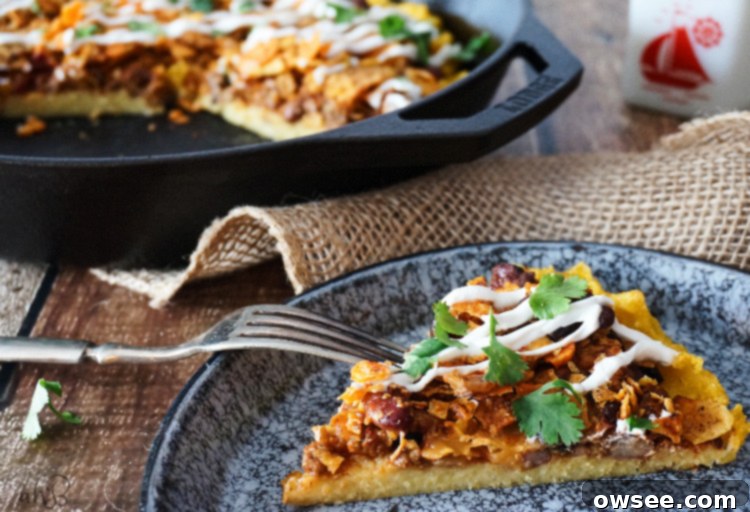 Crispy-edged, creamy-centered polenta topped with chili, cheese, and crunchy crushed nacho chips. A perfect frugal leftover makeover.