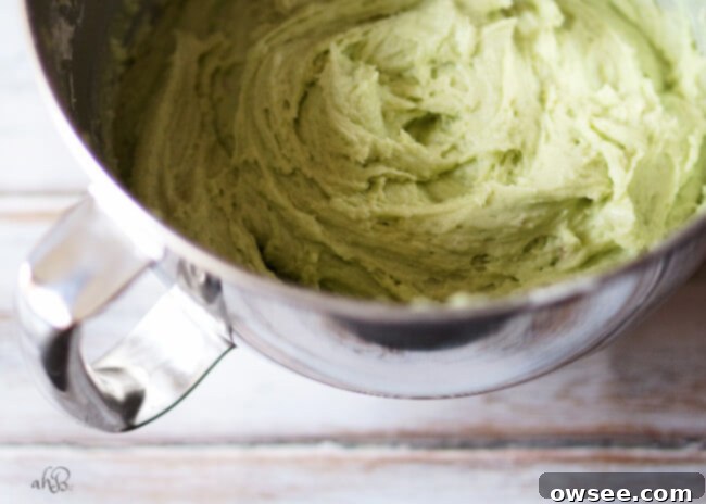 Vibrant green pistachio pudding cake batter in a mixing bowl