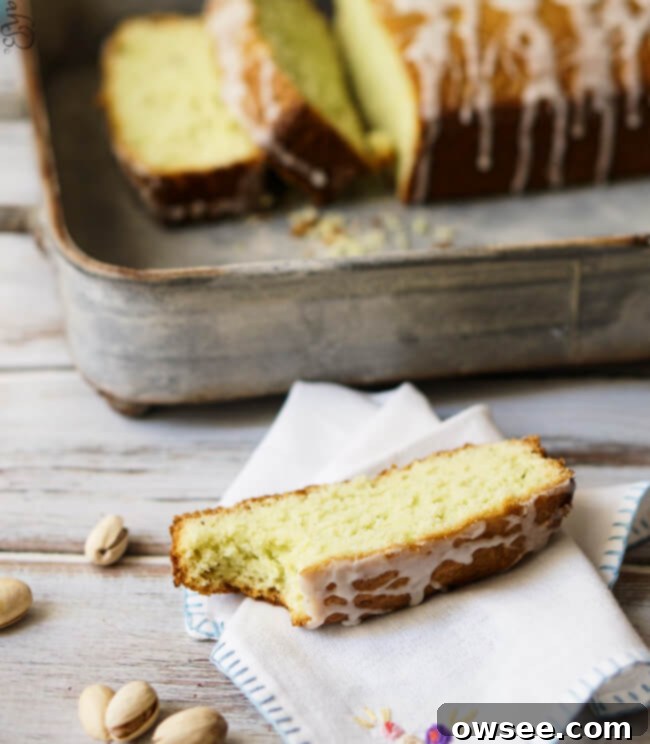 A delectable slice of pistachio pudding pound cake, revealing its tender, moist interior with a bite taken out