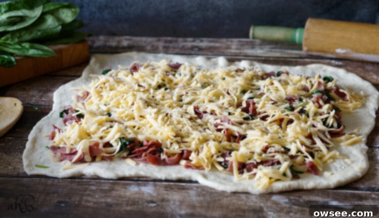 Ingredients for Savory Roast Beef and Gouda Rolls spread on dough