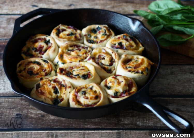 Sliced Savory Roast Beef and Gouda Rolls arranged in a cast iron skillet, ready for baking