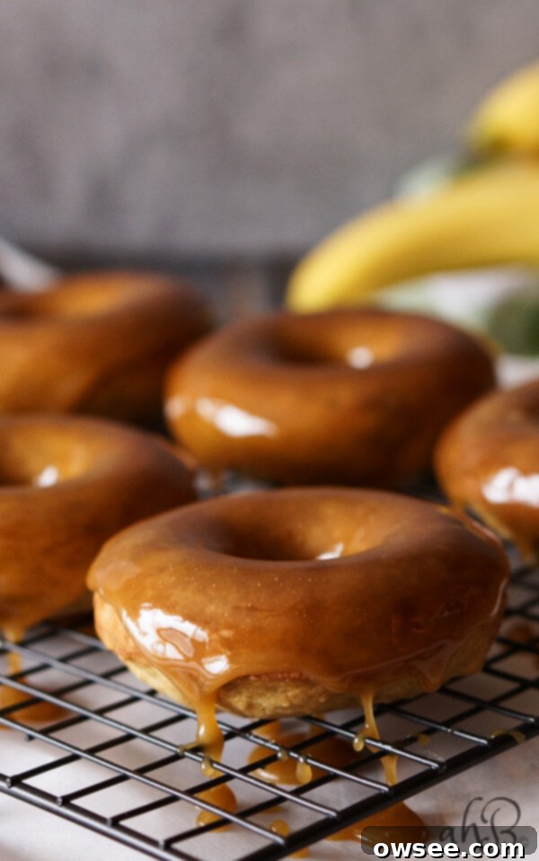 Moist banana bread-like donut dipped in a gorgeous buttery dark caramel glaze that sets up so pretty, with a pinch of salt to even out the sweetness. Recipe on www.accidentalhappybaker.com @AHBamy