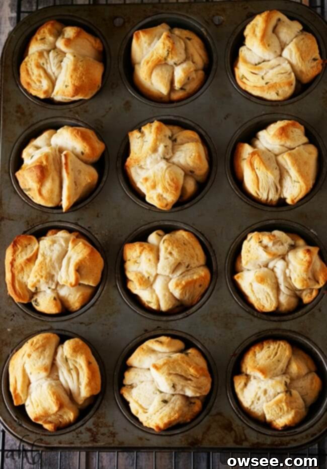Effortless Garlic Sharing Rolls 4 Uncooked biscuit pieces tossed in garlic butter, ready to be baked into easy pull apart garlic rolls.