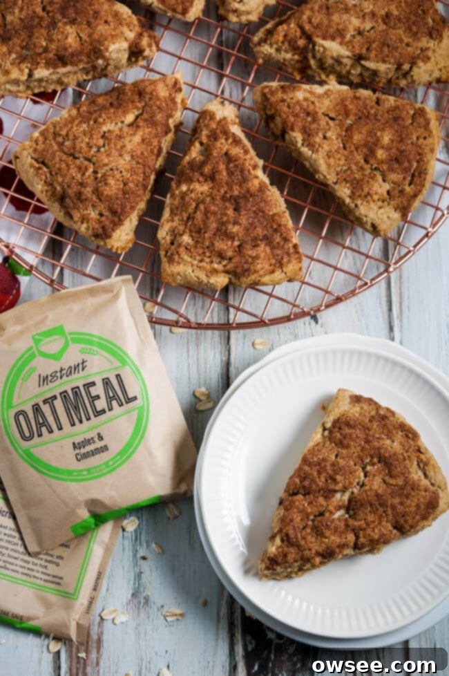 Effortless Oatmeal Scones 2 Golden brown instant oatmeal scones cooling on a wire rack, sprinkled with cinnamon sugar.