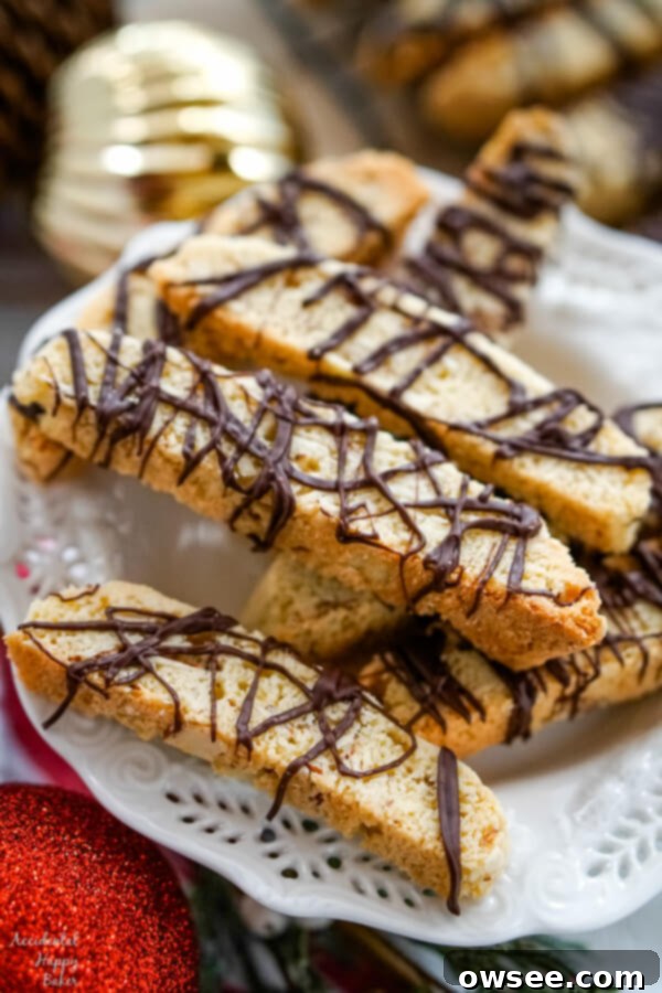 Irresistible Chocolate Almond Biscotti 6 A white serving plate with a pile of Chocolate Almond Biscotti stacked on top.