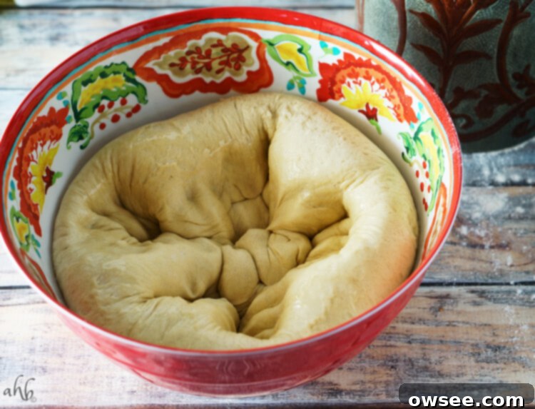 Fluffy Homemade Hawaiian Rolls 7 Hands punching down Hawaiian roll dough to release air.