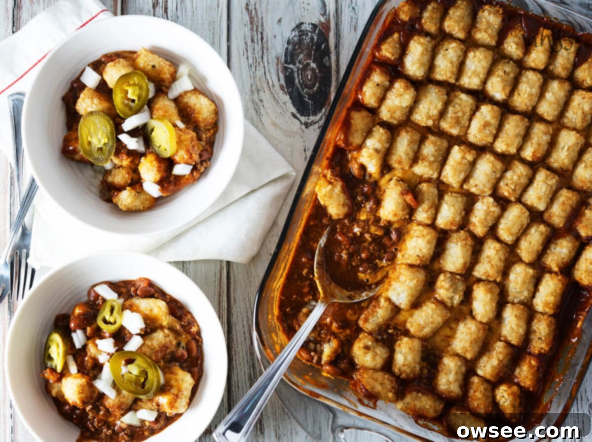 Two servings of Chili Cheese Tater Tot Casserole next to a casserole pan. 