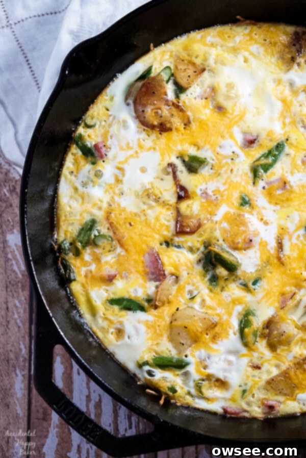 Ham, Asparagus, and Potato Frittata in a cast iron skillet, ready to be served.