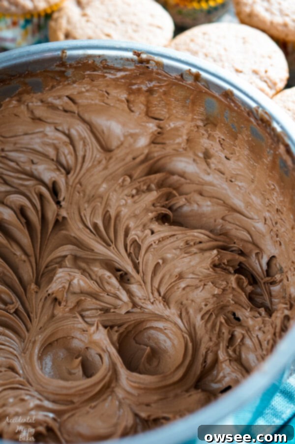 Close-up of a beautifully frosted Spiced Nutella Cupcake, highlighting the creamy chocolate whipped Nutella frosting.