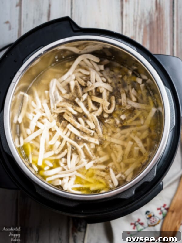 Easy Instant Pot Turkey and Noodles 3 Close-up of creamy turkey and noodles, with a fork lifting some strands, highlighting the rich texture.