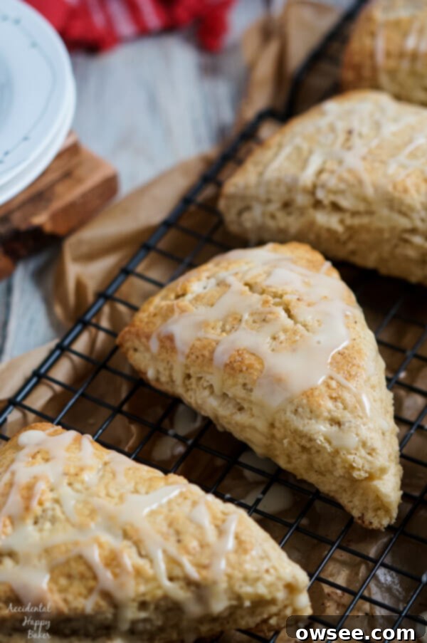 Festive Eggnog Scones 8 Eggnog Scones with a creamy glaze, garnished with cinnamon